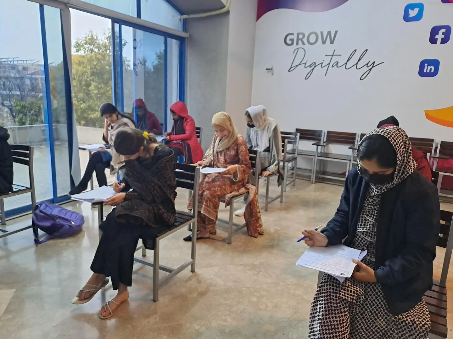 Intermediate learners completing an academic activity in a classroom