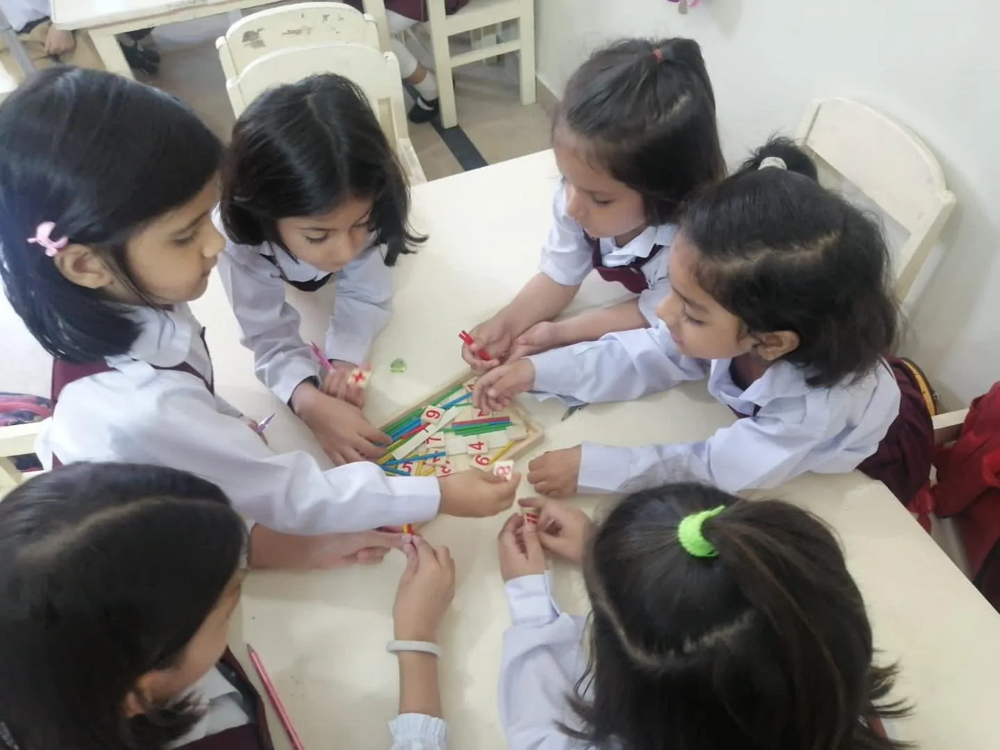 Young students collaborating around a hands-on classroom activity