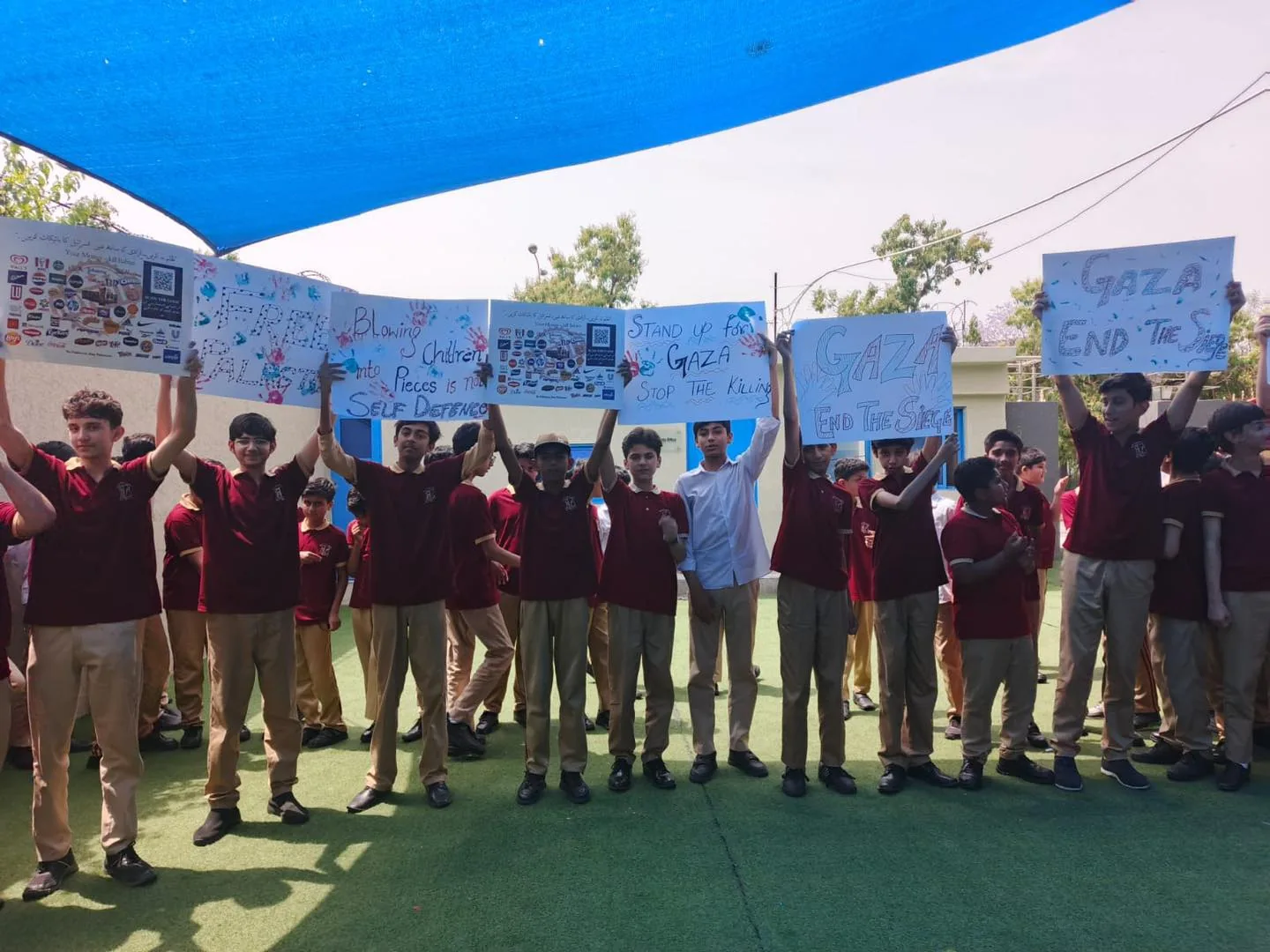 Students holding project placards during a school activity